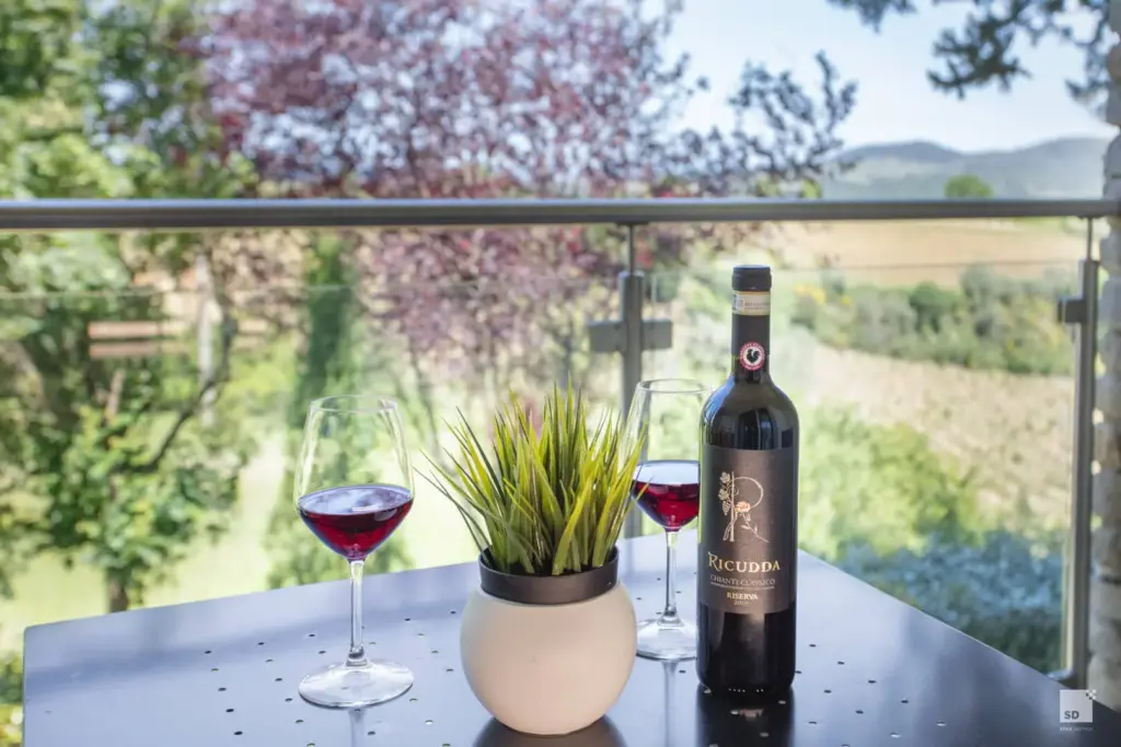 Terrazza con due calici di vino rosso.